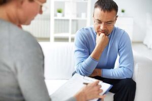 Man talks to health professional during intake for BRC recovery programs
