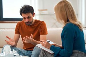 a person talks to a therapist in a depression treatment program