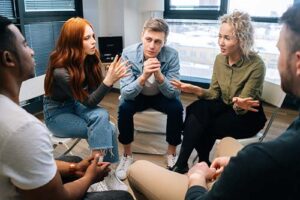 clients talk together in a group therapy program